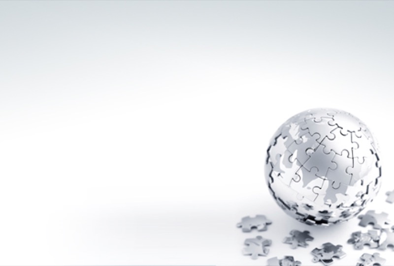 A silver globe made of jigsaw pieces